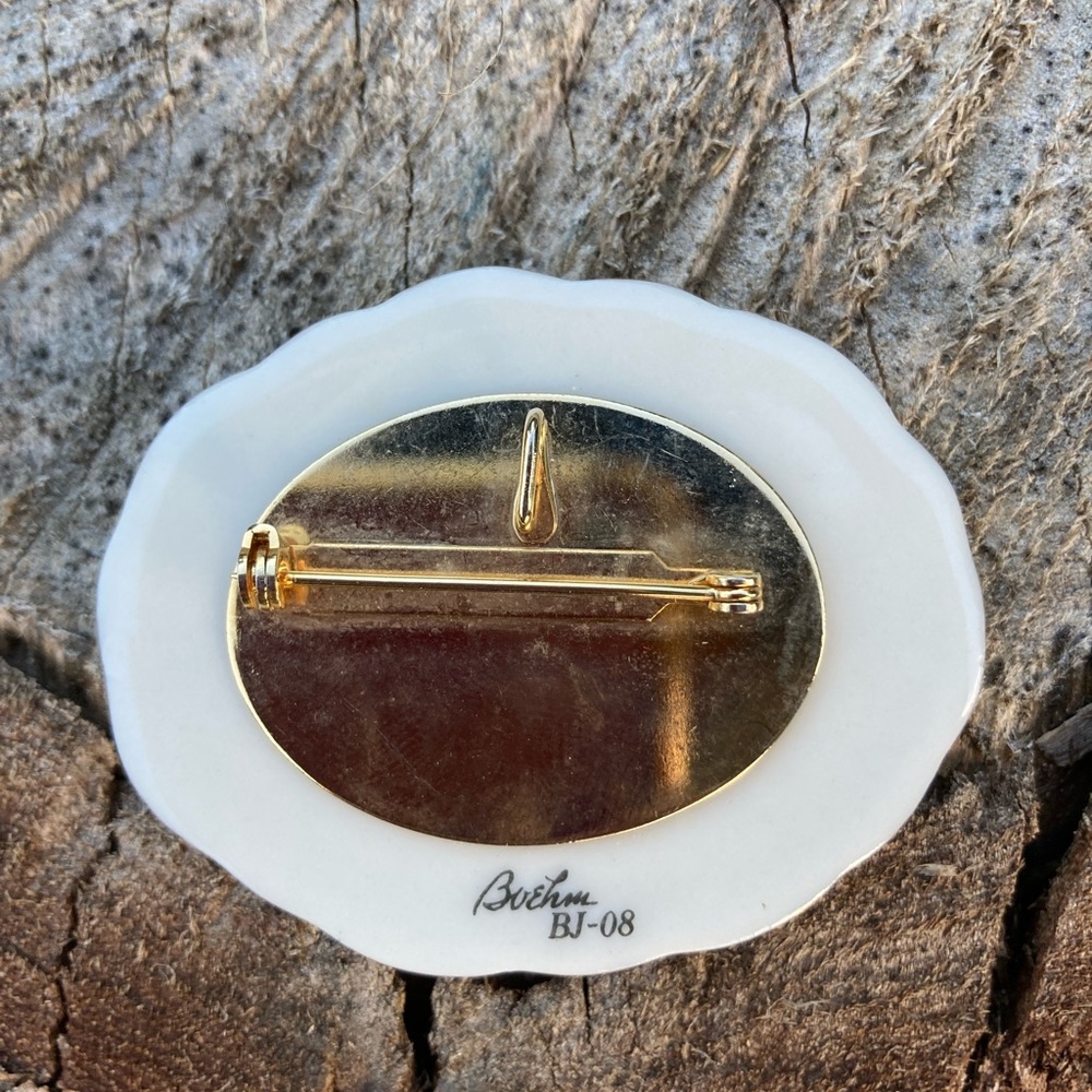Signed Bohem porcelain brooch.